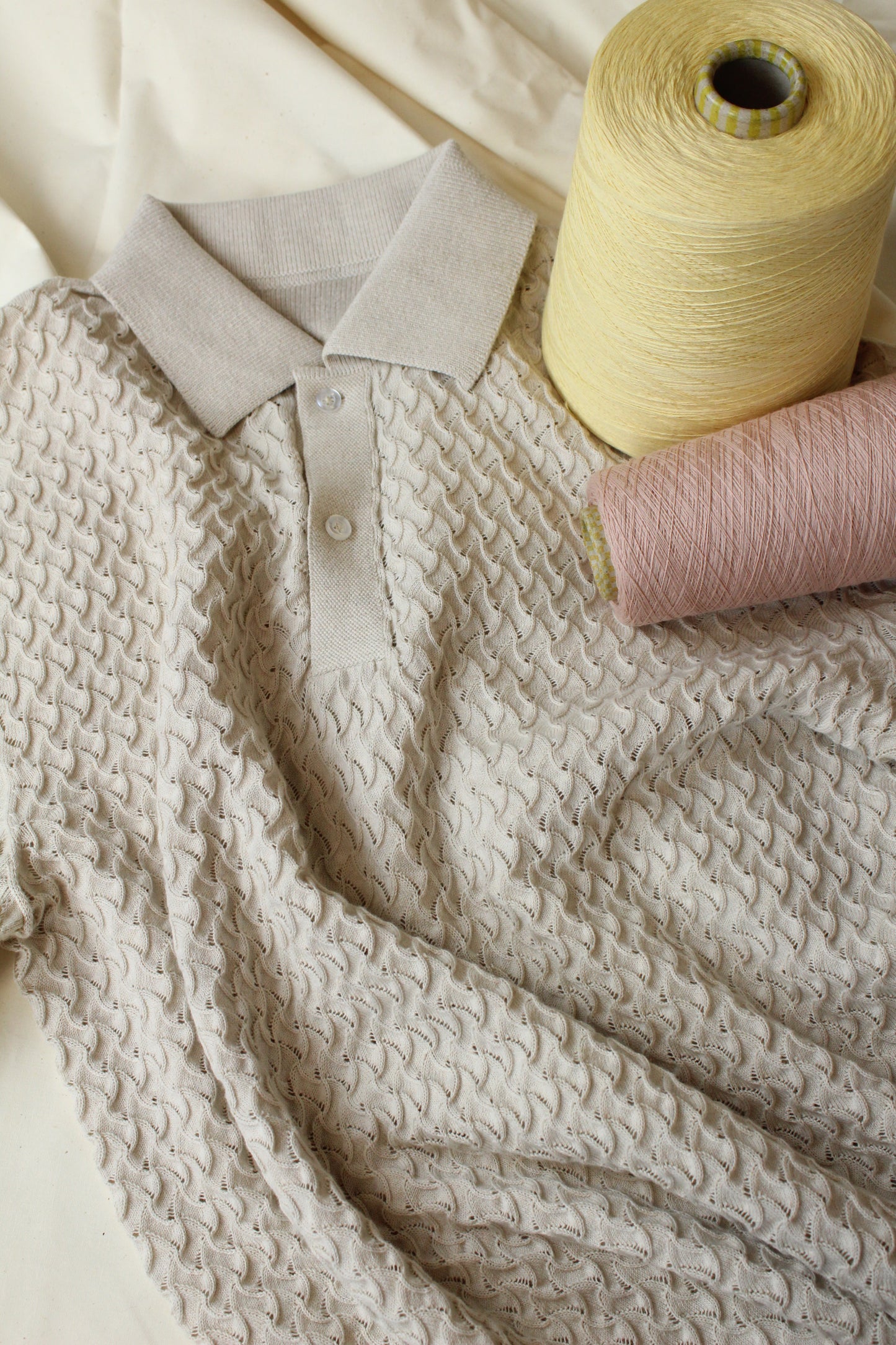 tan textured polo with yellow and dusty pink yarn